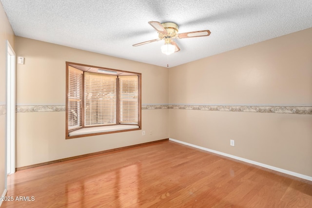 unfurnished room featuring light wood-type flooring, a textured ceiling, and ceiling fan