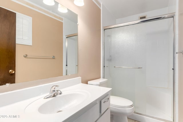 bathroom featuring vanity, toilet, and an enclosed shower