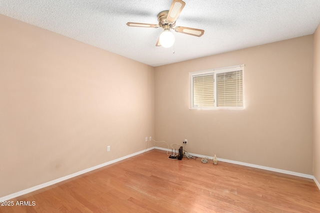 unfurnished room with ceiling fan, a textured ceiling, and light hardwood / wood-style flooring