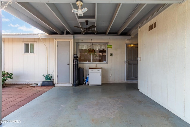 doorway to property with ceiling fan and a patio area