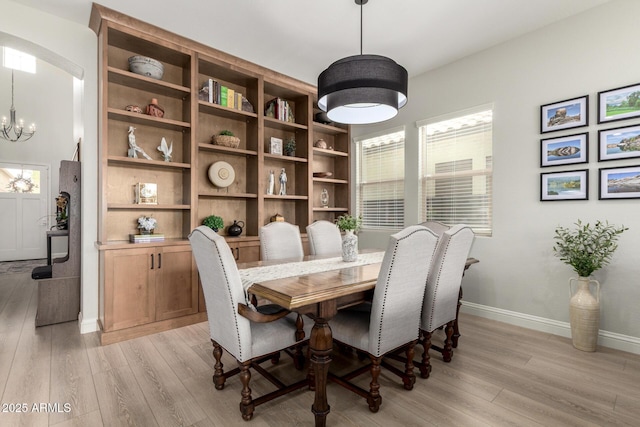 2605 S Quaintance St, Gilbert, AZ 85295 - dining space with light wood-style flooring, a chandelier, and baseboards