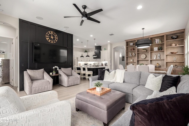 2605 S Quaintance St, Gilbert, AZ 85295 - living room with arched walkways, ceiling fan, light wood-type flooring, and recessed lighting