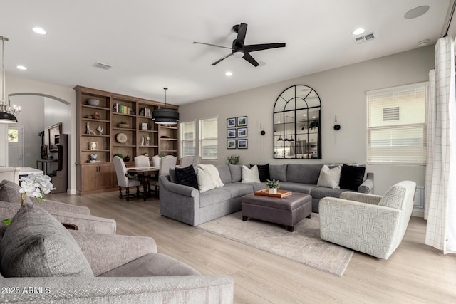 2605 S Quaintance St, Gilbert, AZ 85295 - living area featuring a ceiling fan, light wood-type flooring, arched walkways, and recessed lighting