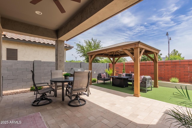 2605 S Quaintance St, Gilbert, AZ 85295 - fenced backyard with a gazebo, a ceiling fan, a patio area, and an outdoor living space with a fire pit