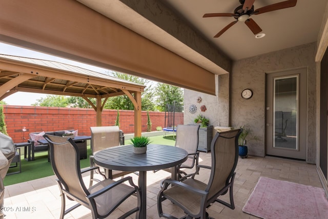 2605 S Quaintance St, Gilbert, AZ 85295 - view of patio / terrace with outdoor dining area, a gazebo, a ceiling fan, and a trampoline