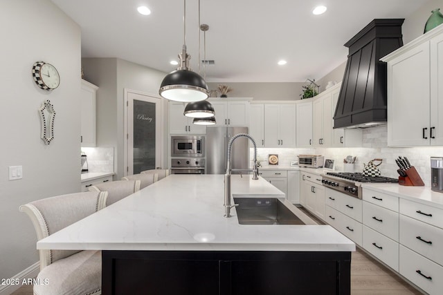 2605 S Quaintance St, Gilbert, AZ 85295 - kitchen with appliances with stainless steel finishes, a sink, custom range hood, tasteful backsplash, and recessed lighting