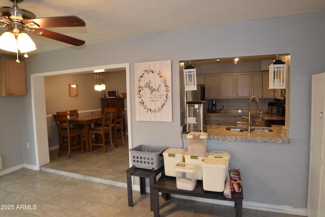 dining area featuring sink, light tile patterned floors, and ceiling fan