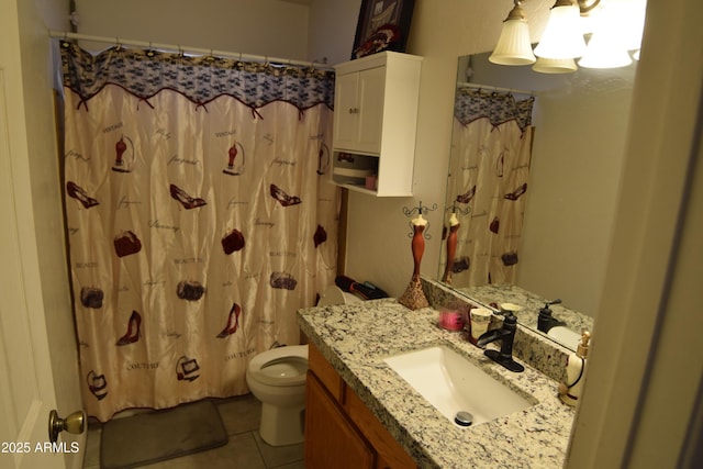 bathroom featuring a shower with shower curtain, vanity, toilet, and tile patterned flooring