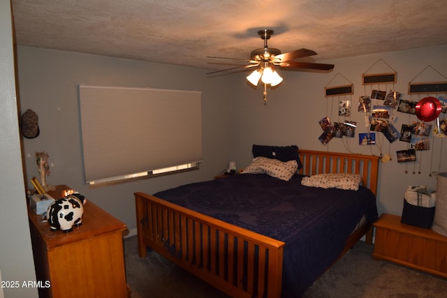 bedroom with ceiling fan, dark carpet, and a textured ceiling