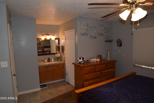 tiled bedroom featuring connected bathroom and sink