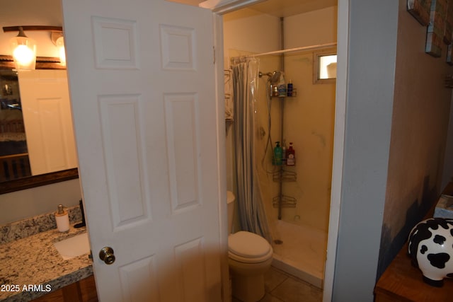 bathroom with tile patterned flooring, toilet, vanity, and a shower with shower curtain