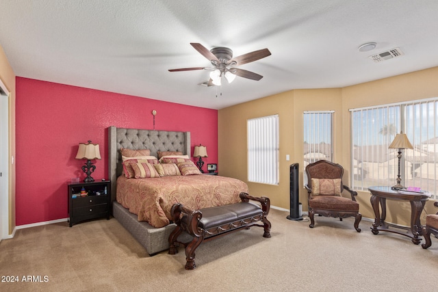 bedroom with carpet flooring, ceiling fan, and a textured ceiling