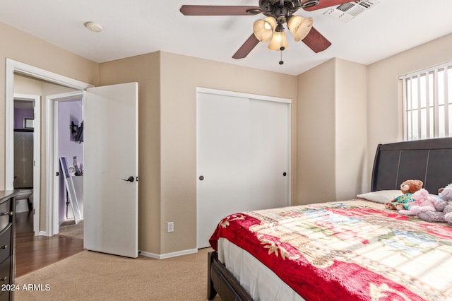 bedroom with carpet, ceiling fan, and a closet