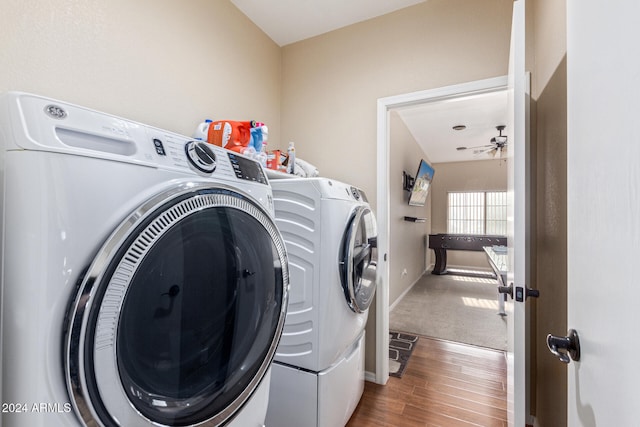 clothes washing area with separate washer and dryer, ceiling fan, and dark wood-type flooring