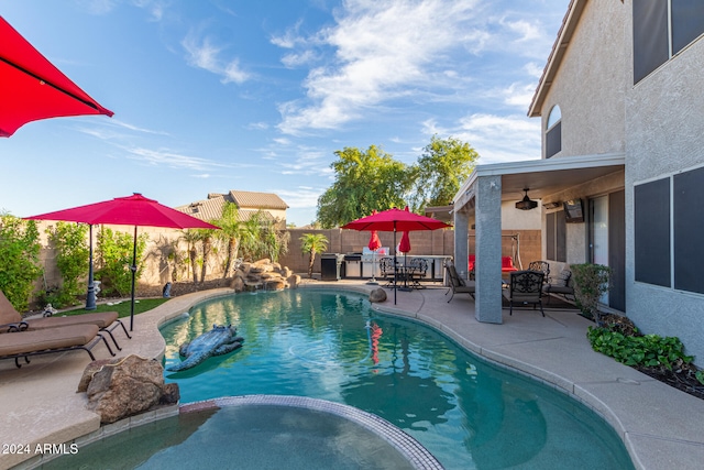 view of swimming pool with an outdoor hangout area, ceiling fan, and a patio area