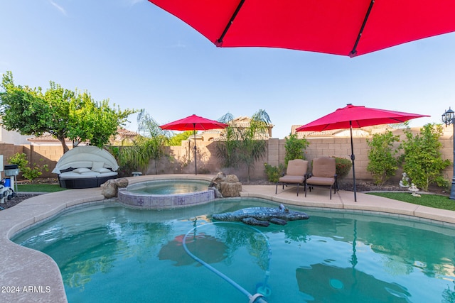 view of pool with a patio area and an in ground hot tub