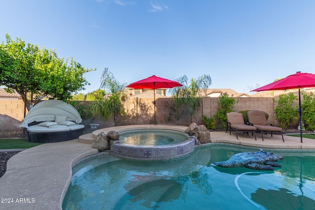 view of swimming pool with an in ground hot tub and a patio area