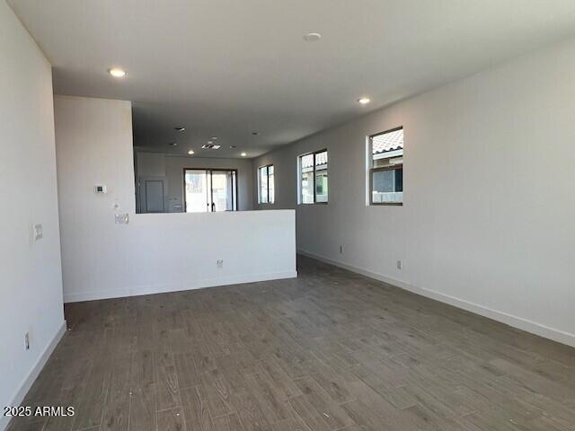 unfurnished room with dark hardwood / wood-style flooring