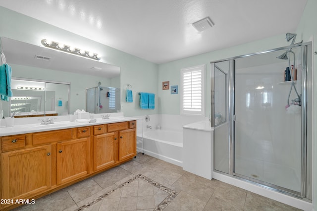 bathroom with tile patterned floors, vanity, and independent shower and bath