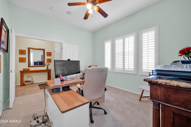 carpeted office space with ceiling fan