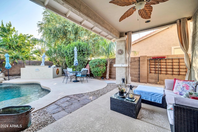 view of patio / terrace with a fenced in pool, ceiling fan, and an outdoor hangout area