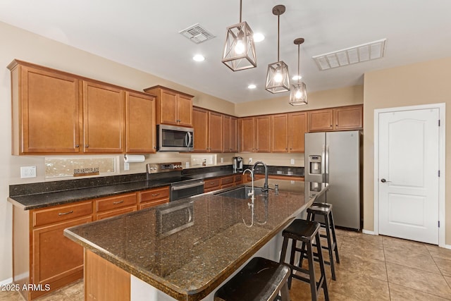 291 E Canyon Rock Rd, San Tan Valley, AZ 85143 - kitchen featuring brown cabinetry, stainless steel appliances, visible vents, and a sink