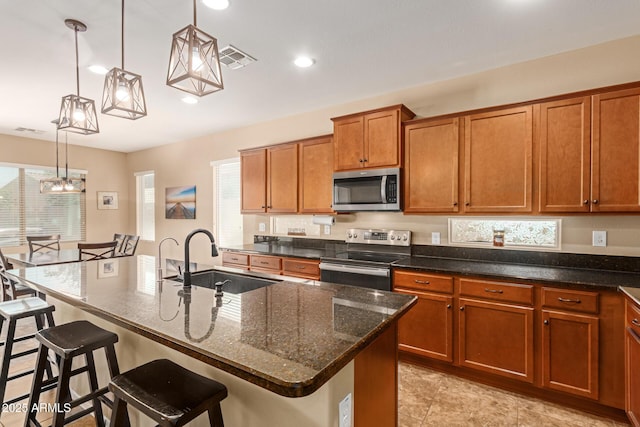 291 E Canyon Rock Rd, San Tan Valley, AZ 85143 - kitchen with brown cabinets, a breakfast bar area, stainless steel appliances, and a sink