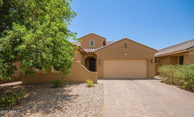 291 E Canyon Rock Rd, San Tan Valley, AZ 85143 - mediterranean / spanish house featuring stucco siding, a tile roof, driveway, and a garage