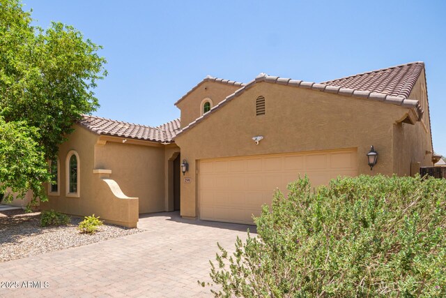 291 E Canyon Rock Rd, San Tan Valley, AZ 85143 - view of front of property featuring stucco siding, decorative driveway, a tiled roof, and a garage