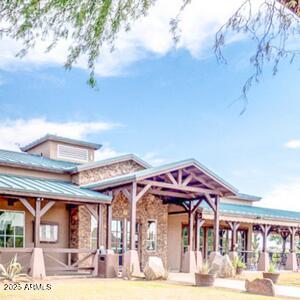 291 E Canyon Rock Rd, San Tan Valley, AZ 85143 - back of property with stucco siding, stone siding, and covered porch