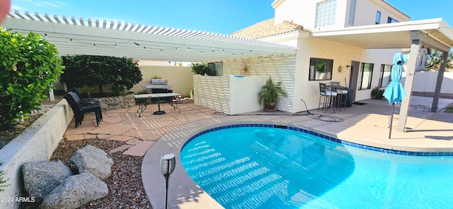 view of pool with a patio and a pergola