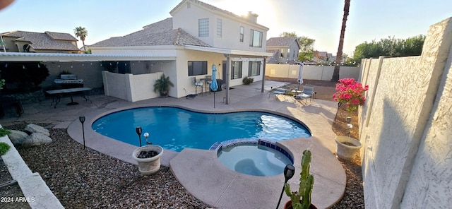 view of pool featuring an in ground hot tub and a patio