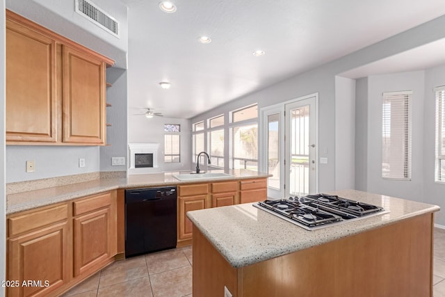 kitchen featuring visible vents, stainless steel gas cooktop, dishwasher, light tile patterned floors, and a sink