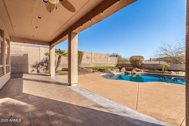 view of patio / terrace with a fenced in pool, a fenced backyard, and a ceiling fan