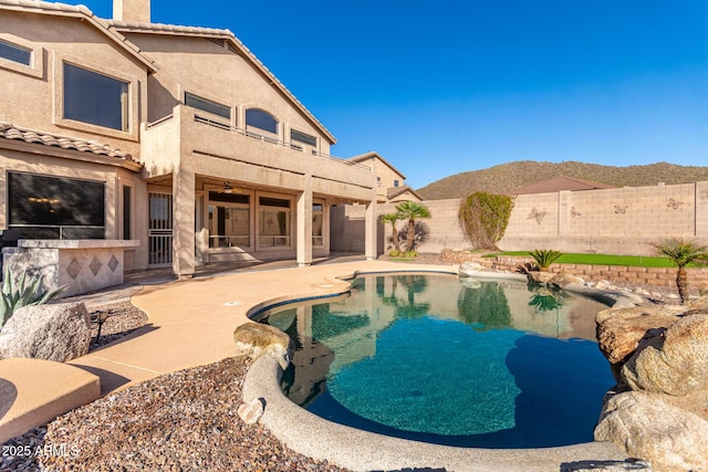 view of pool with a mountain view, a patio, a fenced in pool, and a fenced backyard