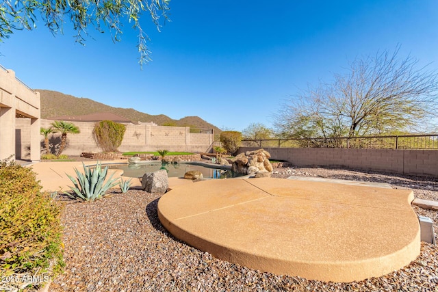 view of yard with a mountain view, a patio, and a fenced backyard