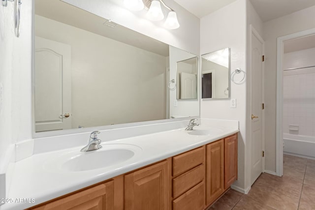 full bath featuring a sink, visible vents, double vanity, and tile patterned floors