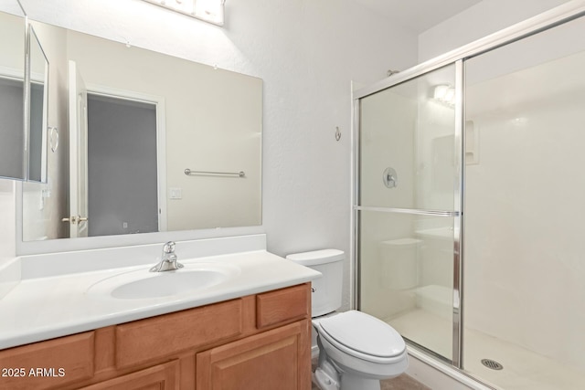 full bath featuring vanity, toilet, and a stall shower