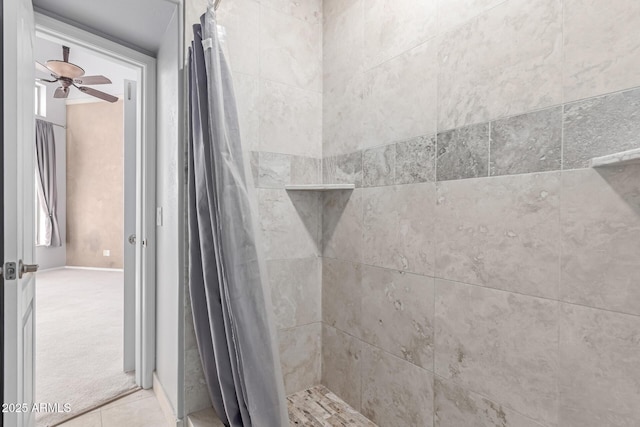 full bath with a tile shower, tile patterned floors, and a ceiling fan