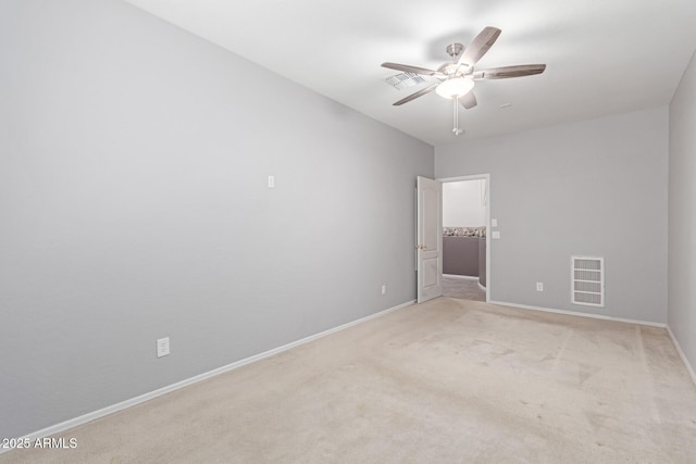 unfurnished room with visible vents, light colored carpet, baseboards, and ceiling fan