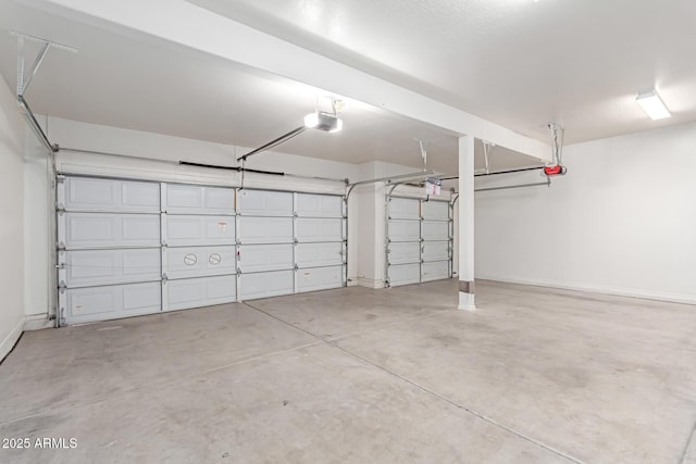 garage with baseboards and a garage door opener