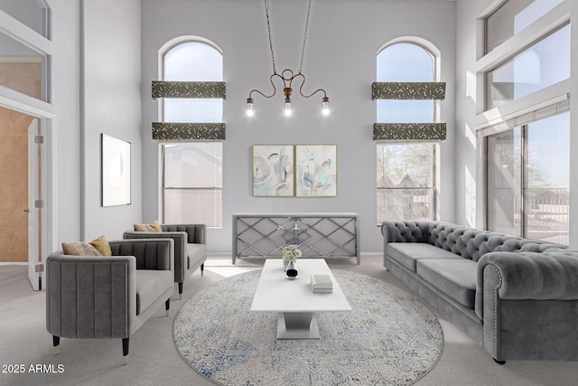 carpeted living area featuring a towering ceiling