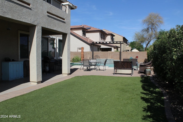 view of yard with a fenced in pool and a patio