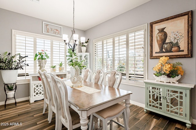 dining room featuring an inviting chandelier and dark wood-type flooring