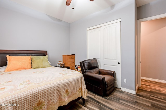 bedroom with ceiling fan, a closet, and dark hardwood / wood-style floors