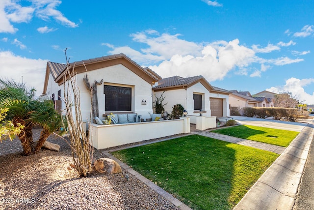 mediterranean / spanish home featuring a garage and a front lawn