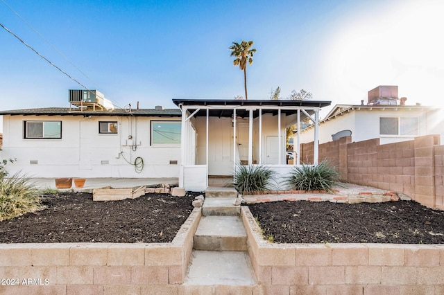 bungalow-style house with cooling unit and a porch