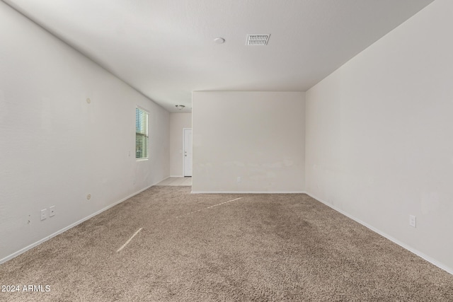 unfurnished room with light carpet