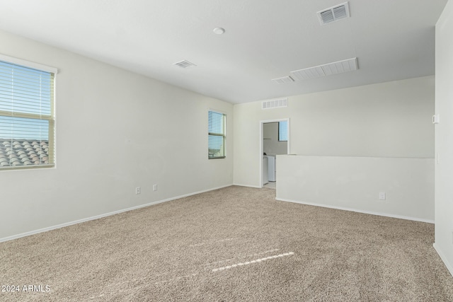 carpeted spare room with a wealth of natural light