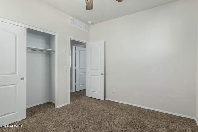 unfurnished bedroom featuring a closet, ceiling fan, and dark carpet